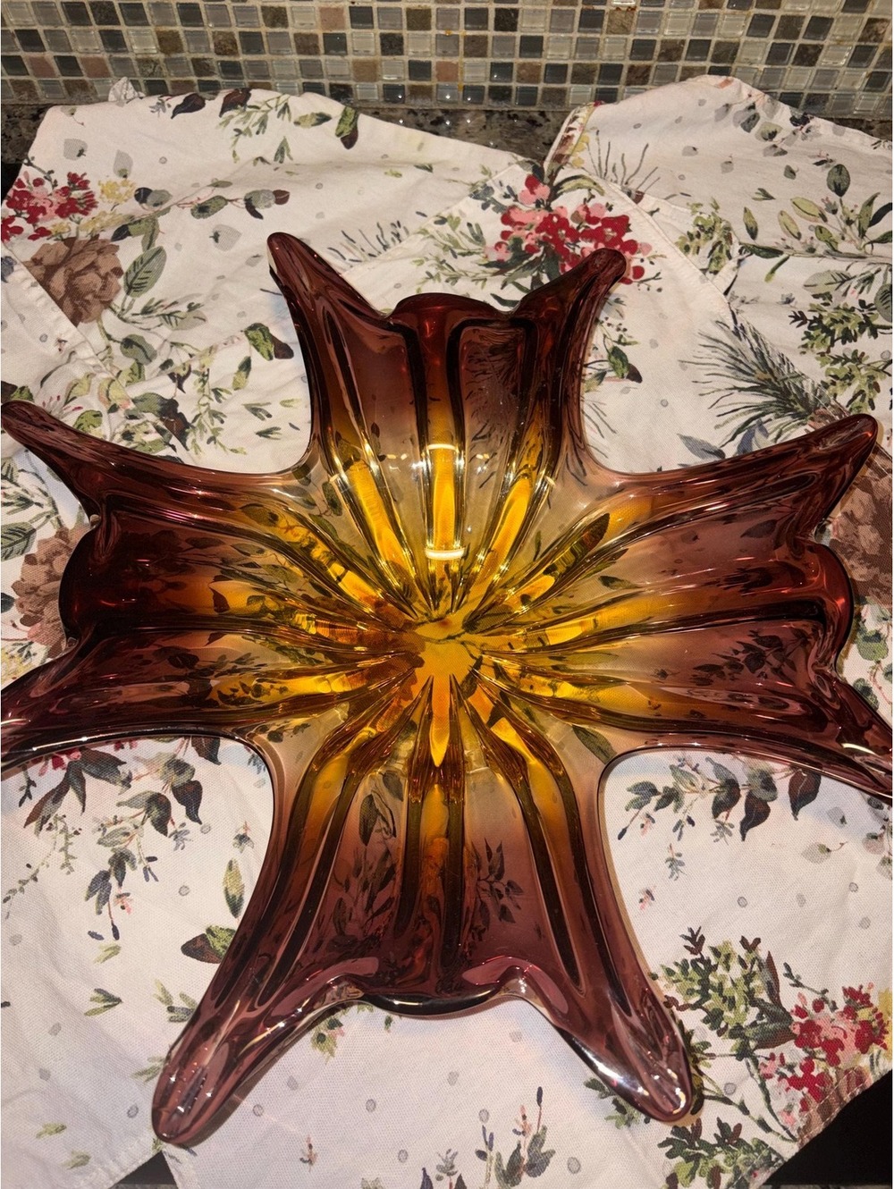 A large amber and purple swung art glass bowl with six points.